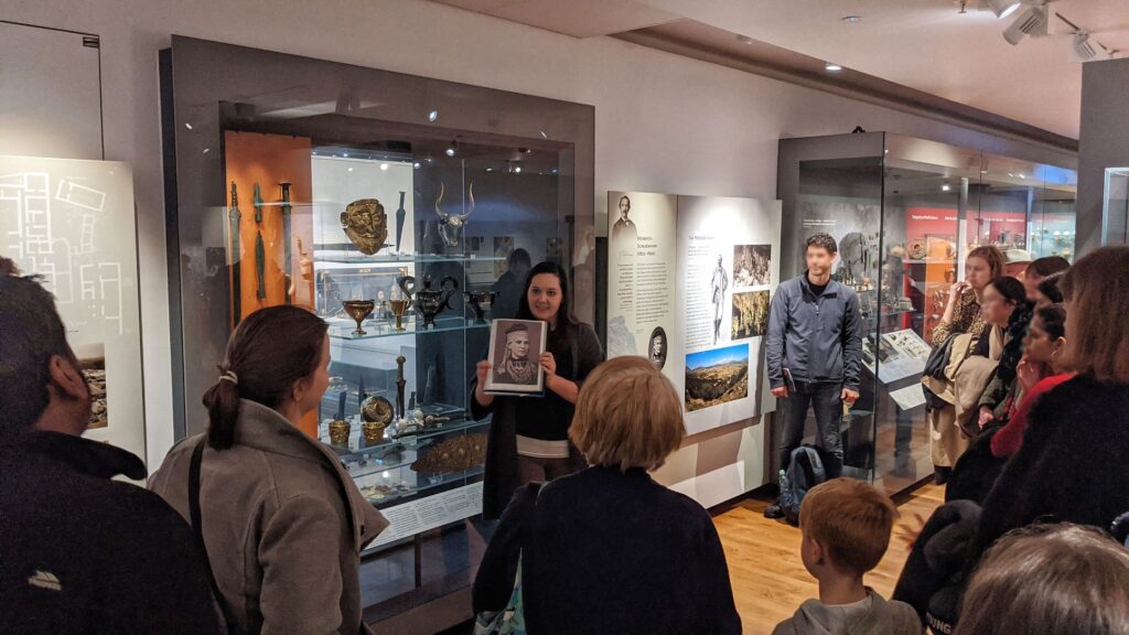 An Uncomfortable Oxford guide presents information to a tour group inside the Ashmolean Museum.