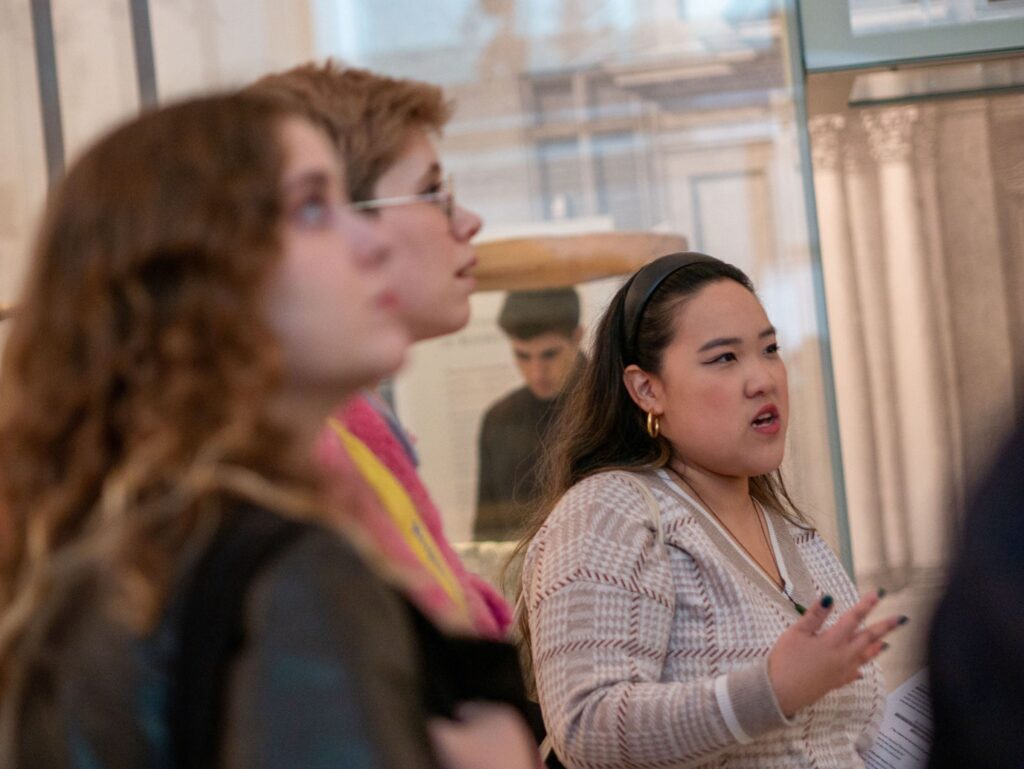 An Uncomfortable Oxford guide presents information to a tour group inside the Ashmolean Museum.