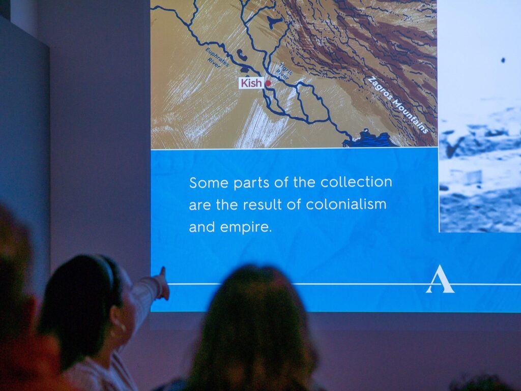 An Uncomfortable Oxford guide presents information to a tour group inside the Ashmolean Museum.
