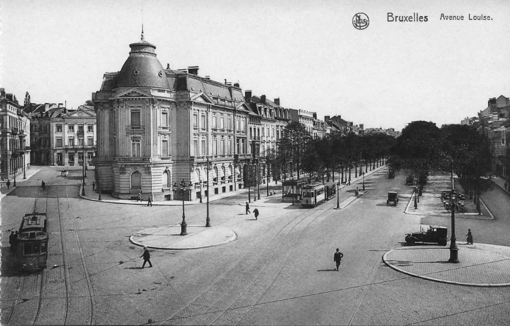 Black and white photograph of a city avenue with a tram