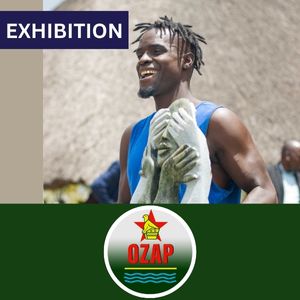 A Zimbabwean artist holds his winning sculpture, with the logo for OZAP in front.